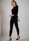 Woman wearing a black outfit on a plain background