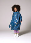 Person wearing a blue floral raincoat on a plain background