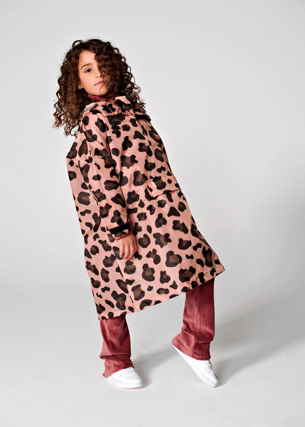 Person wearing a pink leopard print coat on a white background