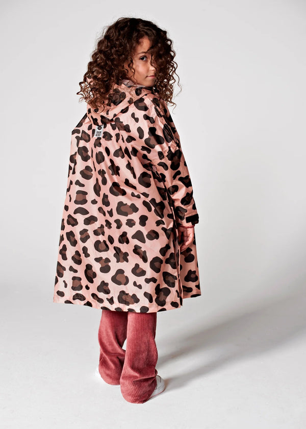 Child wearing a pink coat with a leopard print pattern on a white background