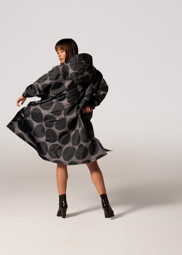 Woman wearing a black and gray patterned dress on a white background