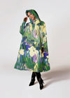 Person wearing a colorful floral raincoat on a white background