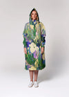 Person wearing a colorful floral-patterned raincoat on a white background