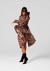 Woman wearing a leopard print dress on a white background