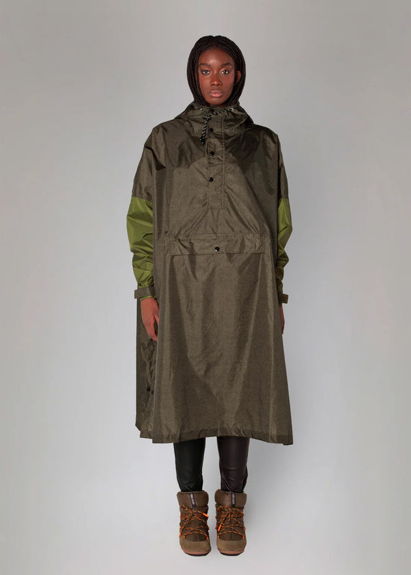 Person wearing a long green raincoat with a hood on a white background