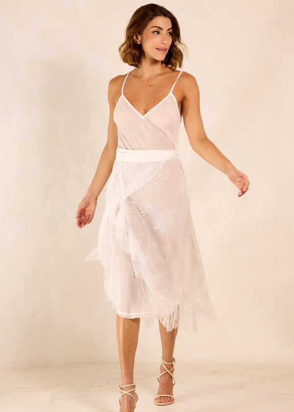 Woman wearing a light pink dress with a plain background