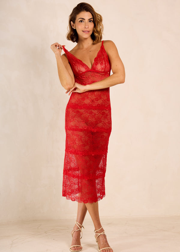 Woman wearing a red lace dress against a beige background